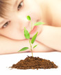 boy looks at a young plant...