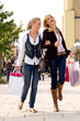 Two young girls shopping in the sunny weather Two young girls shopping in the sunny weather