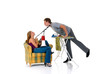 Young bossy woman with megaphone man ironing clothing