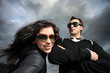 Photo: Cool young couple over dramatic cloudy sky Cool young couple over dramatic cloudy sky