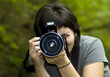 Young female photographer in forest Young female photographer in forest
