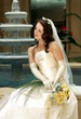 Beautiful bride in white dress holding bouquet