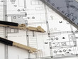 dividers and ruler laying on architectural plan