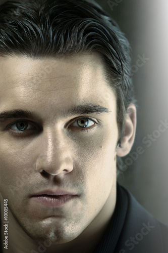 Photo: Close up portrait of young man staring into the lens Close up portrait of young man staring into the lens