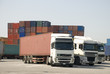 Photo en ligne au meilleur prix Trucks and freight containers in a logistic center