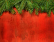 Branches of pine against rustic red wood
