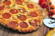 Freshly baked pepperoni pizza on wooden board