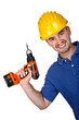 young caucasian manual worker with drill background young caucasian manual worker with drill background