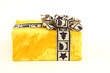 Christmas present in yellow original paper with beautiful tie