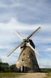 Traditional Old dutch windmill in Latvia against blue sky Traditional Old dutch windmill in Latvia against blue sky