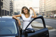 Photo: Young woman holding keys to new car . Young woman holding keys to new car .