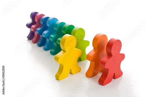 Photo: Line of colorful wooden people - one person stand out of line. Line of colorful wooden people - one person stand out of line.