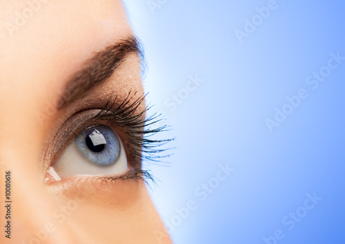 Human eye on blue background (shallow DoF)