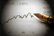 pen over a financial graph