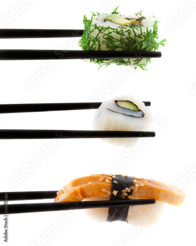 Sushi with chopsticks shot on white.
