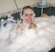 Woman with having fun in foamy bath tub