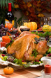Garnished roasted turkey on holiday decorated table