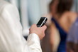 Male hand holding a cell phone, white/caucasian.