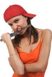 angry young woman wearing, holding a large knife in a mouth.