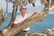 portrait of a content senior man relaxing outdoors