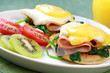 Eggs benedict.  Muffins, spinach, ham,  egg, Hollandaise sauce.