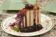 Plate of blueberry cheescake with fresh blueberries
