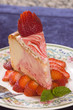 Plate of strawberry cheescake with fresh strawberries