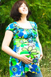 Pregnant woman relaxing on grass Pregnant woman relaxing on grass