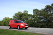 Red van on road. Horizontal.