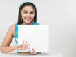 beautiful young woman with a blank placard