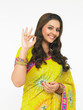 young asian woman of indian origin signaling super