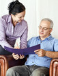 young girl helps a mature man with a form