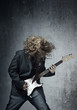 Electric guitar player on a trash background