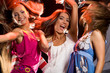 Photo of joyful teenage girls having fun on dance floor