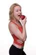 Photo: blond hair woman in workout attire taking a bite of an apple blond hair woman in workout attire taking a bite of an apple
