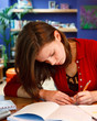 Photo: young female student doing her homework young female student doing her homework