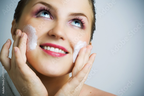 Photo: Beautiful girl massaging her face. Beautiful girl massaging her face.