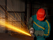 heavy industry manual worker with grinder