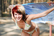 portrait of young happy woman in bikini with blue shal