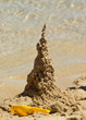 A dribble sand castle on a beach