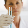 Female Scientist holding up Test Tube.