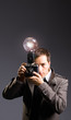Retro photo journalist holding vintage camera with flash bulb