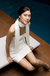 Young Asian Woman Sitting Down