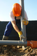 Plumber assembling pvc sewage pipes in house foundation