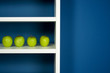 Photo: Green apple inside white bookcase in blue room Green apple inside white bookcase in blue room