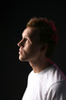 profile of attractive man with receding hair and facial stubble
