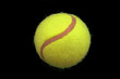 An isolated to black image of a tennis ball