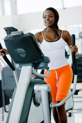Photo: beautiful woman at the gym exercising in the cardio beautiful woman at the gym exercising in the cardio