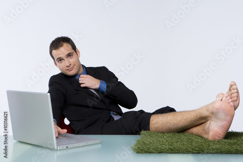 Photo: Businessman with his feet on the grass Businessman with his feet on the grass