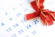 Christmas day concept: calendar with red bow above december 25